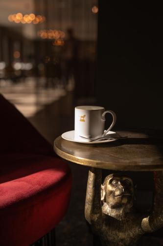 a table with a coffee cup on top of it at Bailiffgate Hotel in Alnwick
