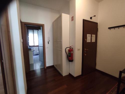 a hallway with a fire hydrant next to a door at Margot's House Rho in Rho