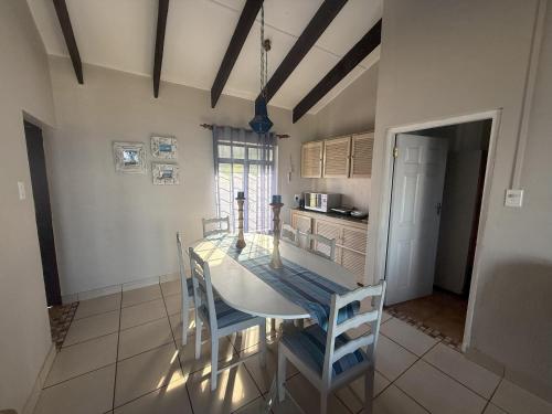 a kitchen with a table and chairs in a room at Sonnestrale in Margate