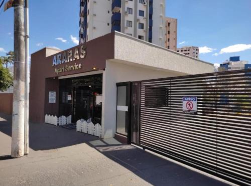 a store with a garage door in front of a building at Apart Hotel CTC - Edifício Araras in Caldas Novas