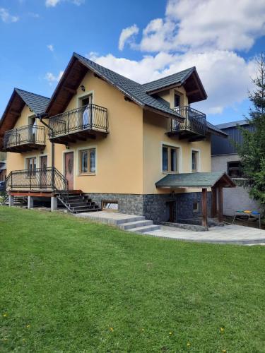 a house with balconies on the side of it at Agroturystyka za wodą - apartamenty in Kacwin