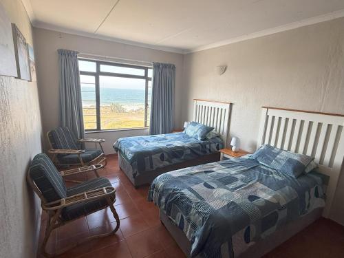 a bedroom with two beds and a view of the ocean at Sonnestrale in Margate