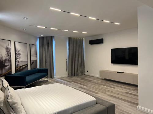 a bedroom with a bed and a flat screen tv at Luxury 3 bedroom apartment with swimming pool Ikoyi in Ikoyi