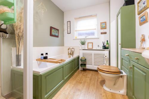 a bathroom with a toilet and a sink at Lochnomore - A Luxury Home With Magnificent Views in Nairn