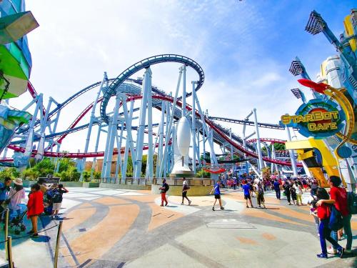 a roller coaster in a amusement park with a crowd of people at Orlando 2BR Retreat 3 Beds Near Disney&Universal in Orlando