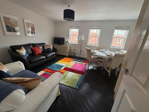 a living room with a couch and a table at 122 The Old Meadow in Shrewsbury
