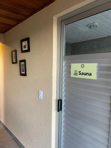 a white garage door with a sign on it at Pariká Pousada in Alto Paraíso de Goiás