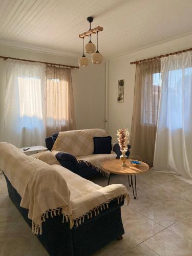 a living room with a couch and a table at Alexas Apartment in Myrina