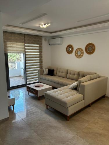 a living room with two couches and a table at Perle de Kelibia S2 Fatha beach sea view in Kelibia