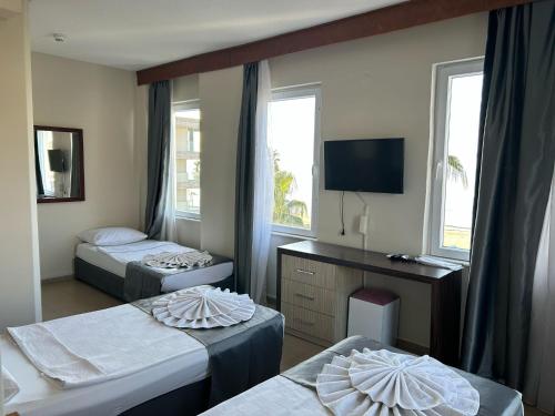 A bed or beds in a room at Rosella Hotel