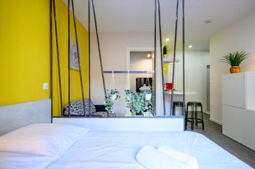 a bedroom with a large mirror above a bed at Le Viette in Montbéliard