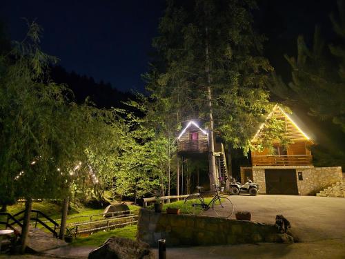 a bike parked in front of a house at night at Etno selo BISTROVO in Vitez
