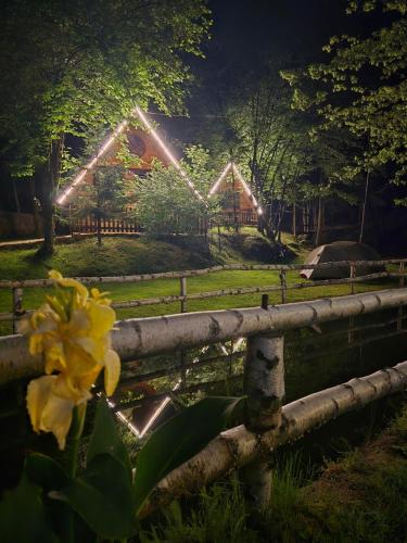 a yellow flower in front of a fence with lights at Etno selo BISTROVO in Vitez