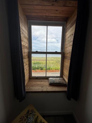 a window in a room with a view of a field at Tidal House in Cambois