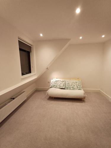 a bedroom with a bed in a attic at Kilby close in Edgware