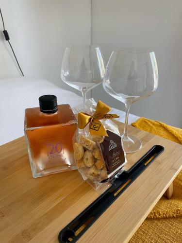 a table with two wine glasses and a bag of crackers at Escale Papillons Peyi Lodge in Le Vauclin