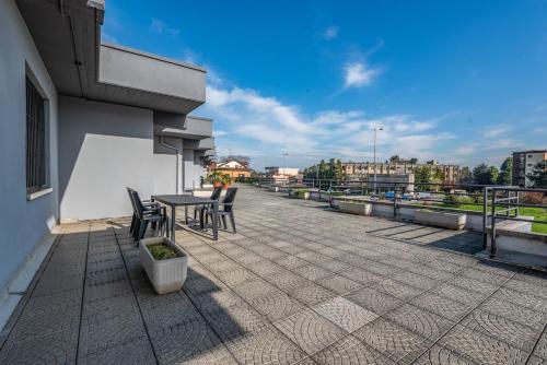 a patio with a table and chairs on a building at three-room apartment with terrace Free Wifi in Bareggio