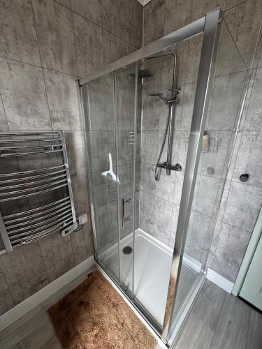 a shower with a glass door in a bathroom at Tidal House in Cambois