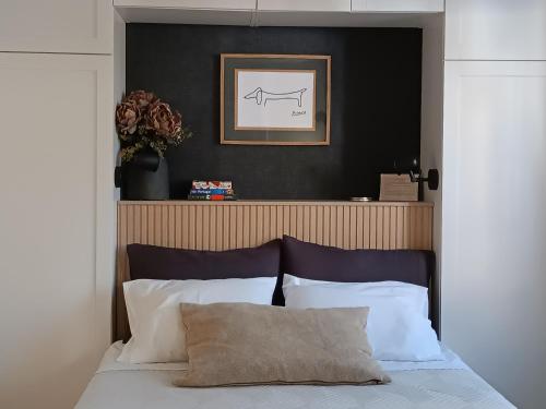 a bedroom with a black wall and a bed with white pillows at Cantinho das Quintãs in Viseu