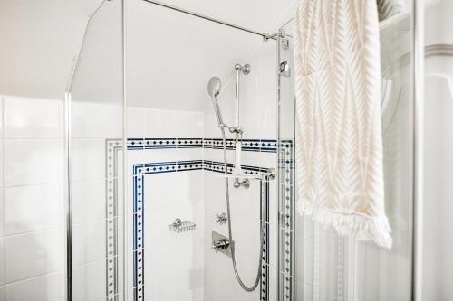 a shower with a glass door in a bathroom at Waldach Villa in Thalgau