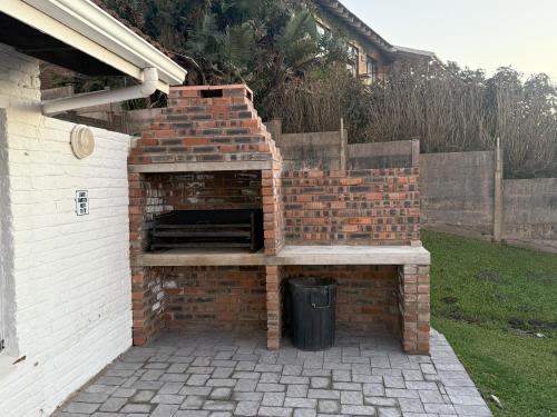 a brick oven in a backyard with a trash can at Sonnestrale in Margate