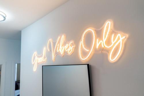 a neon sign that says girls only on a wall at Style & Comfort 3 Rooms 15 min from NYC in West New York
