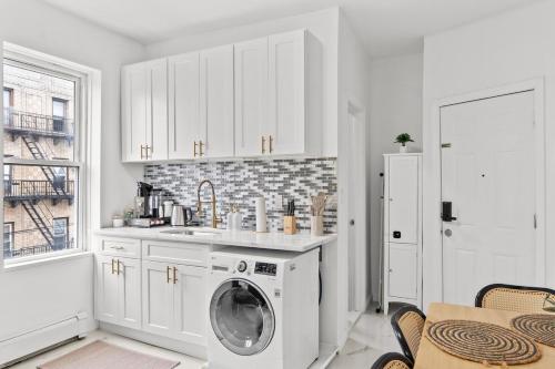 a white kitchen with a washing machine in it at Style & Comfort 3 Rooms 15 min from NYC in West New York