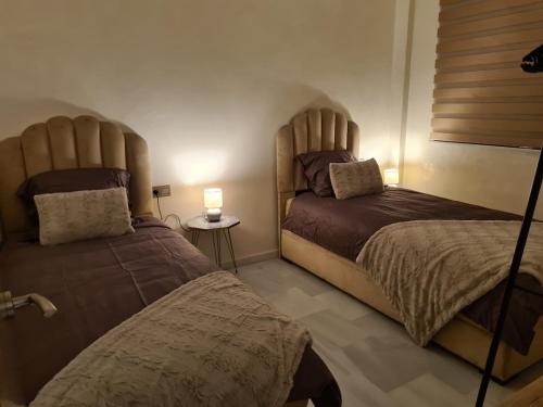 Un ou plusieurs lits dans un hébergement de l'établissement Appartement sur la corniche 2 chambres