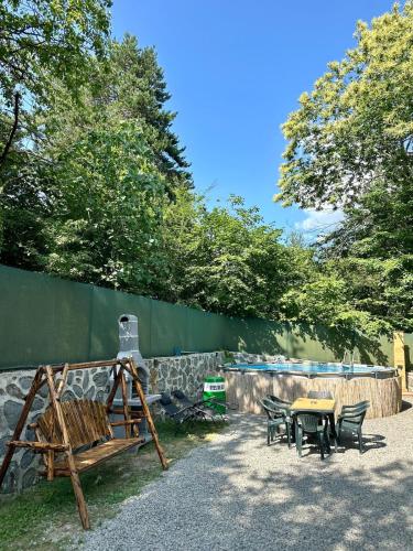a patio with a table and chairs and a fence at Sapanca Orman İçinde Özel Havuzlu Villa in Sakarya