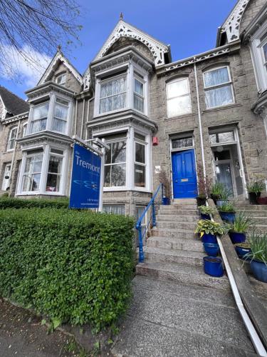 an old house with a blue door and stairs at The Tremont in Penzance