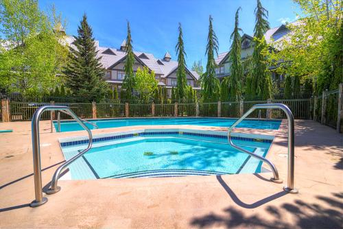 a swimming pool in a yard with a fence at Northstar at Stoney Creek by Whiski Jack in Whistler