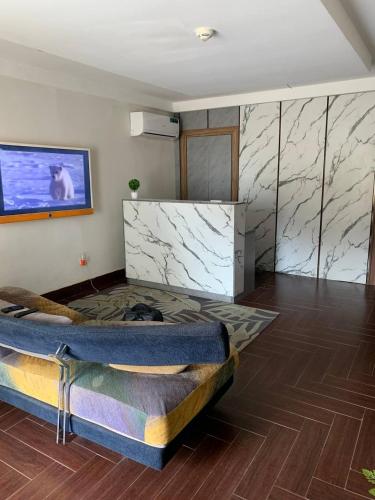 a room with a bed and marble walls at Wellaton Suites in Abuja