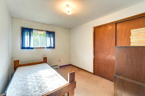 a bedroom with a bed and a wooden door at Fishers Retreat Hayward Home, Near ATV Trails! in Seeley
