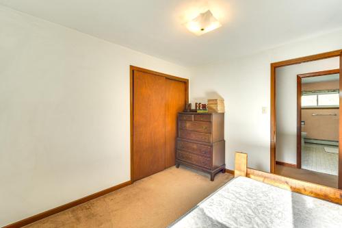 a room with a wooden door and a dresser at Fishers Retreat Hayward Home, Near ATV Trails! in Seeley