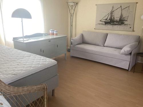 a living room with a couch and a bed at 4 person holiday home in STENINGE in Steninge