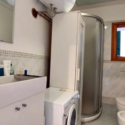 a kitchen with a washing machine in a bathroom at Tuscany WineArt in Riparbella