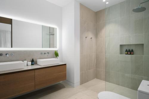 a bathroom with a sink and a shower at South Bank in Long Bay Hills