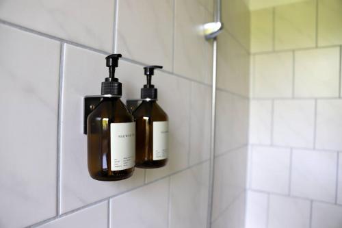two bottles of wine hanging on a wall in a bathroom at chill-in Orange - Pure Nature und Relax in Kirchberg am Wechsel