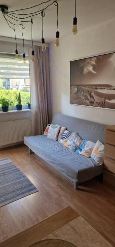 a large bed in a room with a window at Apartament Morze i Rekiny in Reda