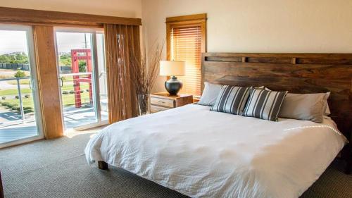 a bedroom with a large white bed and a window at Lighthouse - 3-Bedroom, 3-Bathroom Suite at REAL Watersports in Waves