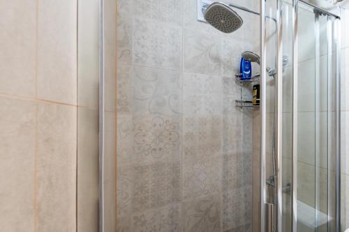 a shower with a glass door in a bathroom at APARTMENT LEA BAYVIEW in Dubrovnik