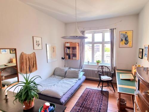 a living room with a couch and a window at Scandinavian city apartment in Aarhus