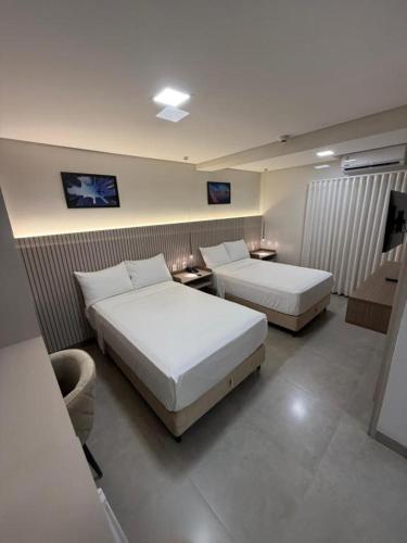 a hotel room with two beds in a room at Alta Vista Hotel in Pedro Juan Caballero