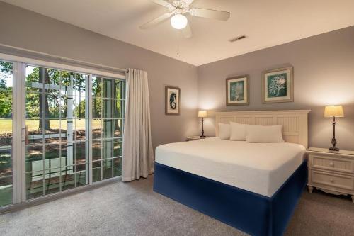 a bedroom with a bed and a large window at Magnolia Run 13 3BR 2BA in Pawleys Island