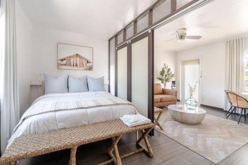 a bedroom with a large bed and a table at Bliss stylish apartment with pool, by beach in Riviera Beach