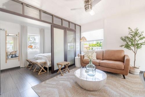 a living room with a couch and a table at Bliss stylish apartment with pool, by beach in Riviera Beach