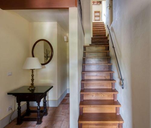 a stairway with a table and a mirror at Villa Le Barone in Panzano