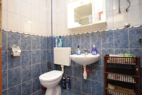 a bathroom with a toilet and a sink at Apartments Milena in Stomorska