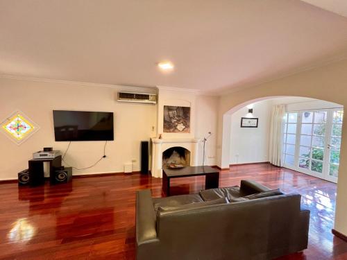 a living room with a couch and a fireplace at Chalet del Hijo Prodigo-wine&suites in Mendoza