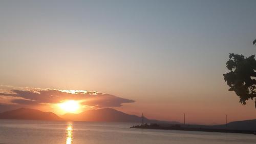 a sunset over a body of water at Rozy Studios in Pefki